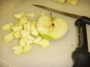Peel the apples and cut them into small pieces.  Dump them into your pot with cold water to keep them from turning brown while you work.